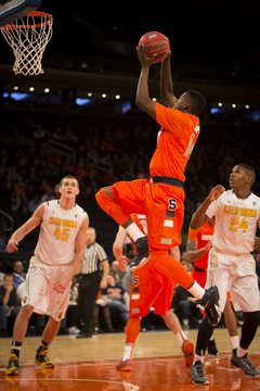 Point guard Kaleb Joseph rises up for a layup as California's David Kravish (left) and Jordan Mathews (right) look on.