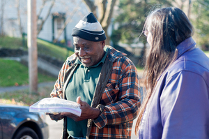 Eugene Broadwater, a Syracuse resident, receives an apple pie from Donna Le'Cartel. Le'Cartel and six student volunteers made 92 pies for the local community. 