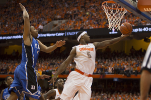 C.J. Fair flies by Jabari Parker in No. 2 Syracuse's 91-89 win over No. 17 Duke on Saturday. Fair scored a career-high 28 points and established himself as the Atlantic Coast Conference's best player. 