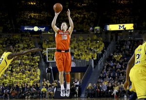 SU guard Trevor Cooney unleashes a shot from deep against Michigan. The junior connected on a pair of 3-pointers to fuel the Orange's comeback attempt late in its eventual loss to UM.