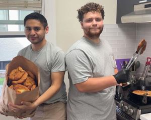 Native Student Program coordinator Darrin White and Indigenous Students at Syracuse e-board officer Ryan Bouchey make traditional fry bread. The food is a staple in some Indigenous groups.
