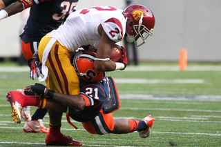 Syracuse Orange safety Shamarko Thomas #21 makes a tackle on USC Trojans wide receiver Robert Woods #2. 