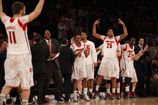 Louisville teammates cheer as they pull ahead in the middle of the second half.