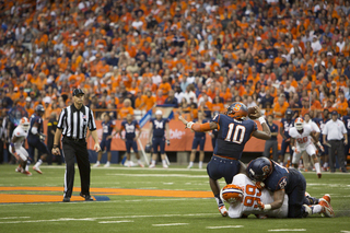 Hunt attempts a pass while being brought down in the backfield.