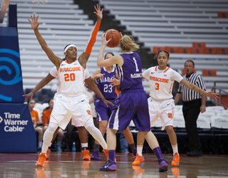 Brittney Sykes (left) and Rachel Coffey (right) defend against Niagara's Meghan McGuinness (center). 