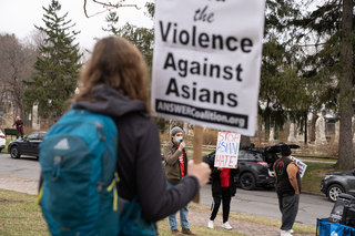 Sohrob Aslamy, a doctoral student and an organizer with the Syracuse Party for Socialism and Liberation, welcomes a crowd of demonstrators at Thornden Park. The Syracuse PSL and the Syracuse ANSWER Coalition held a rally on Saturday to protest anti-Asian violence.